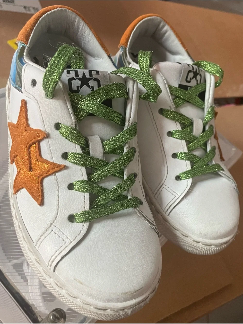 Kids White Sneakers with Orange Star Accents and Green Glitter Laces